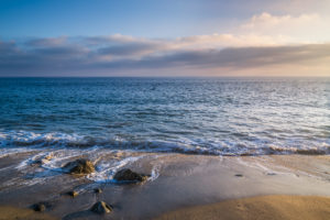 Rocks laying by the sea enjoying the incoming waves at Point Mugu in Malibu, CA.